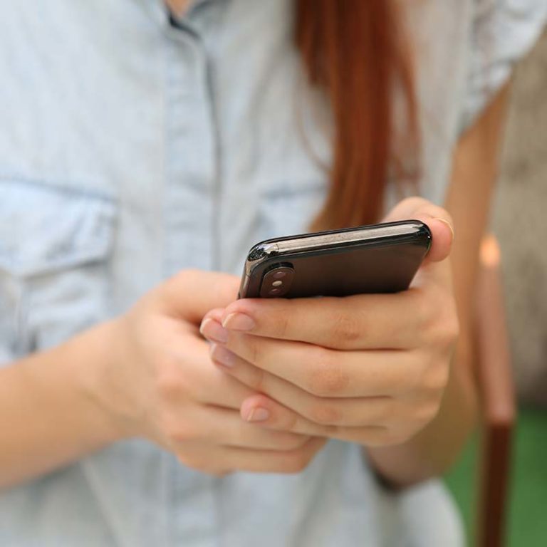 Women's hands holding smartphone