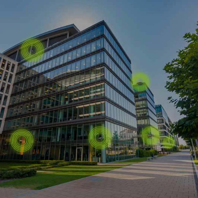 Office building with green circle graphics overlaid