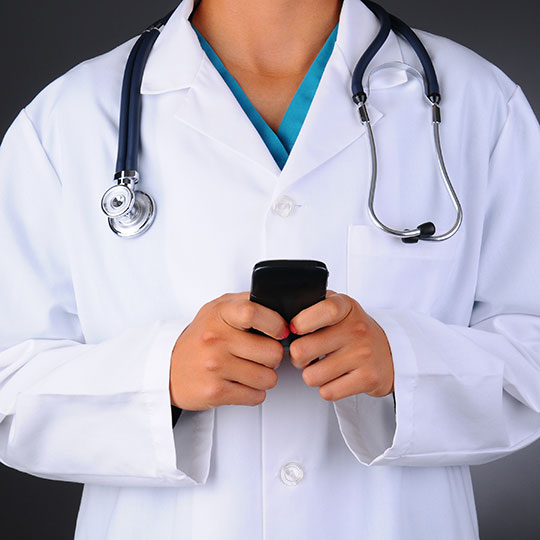 Doctor holding smart phone