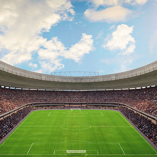 Interior of soccer stadium with packed crowd in the stands