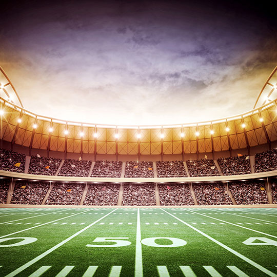 Interior of packed football stadium with an open ceiling