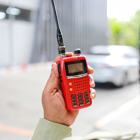 Hand holding an emergency response radio