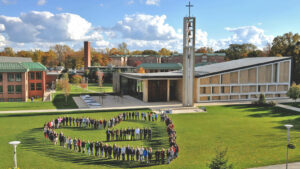 A group of people forming a heart at Sacred Heart University
