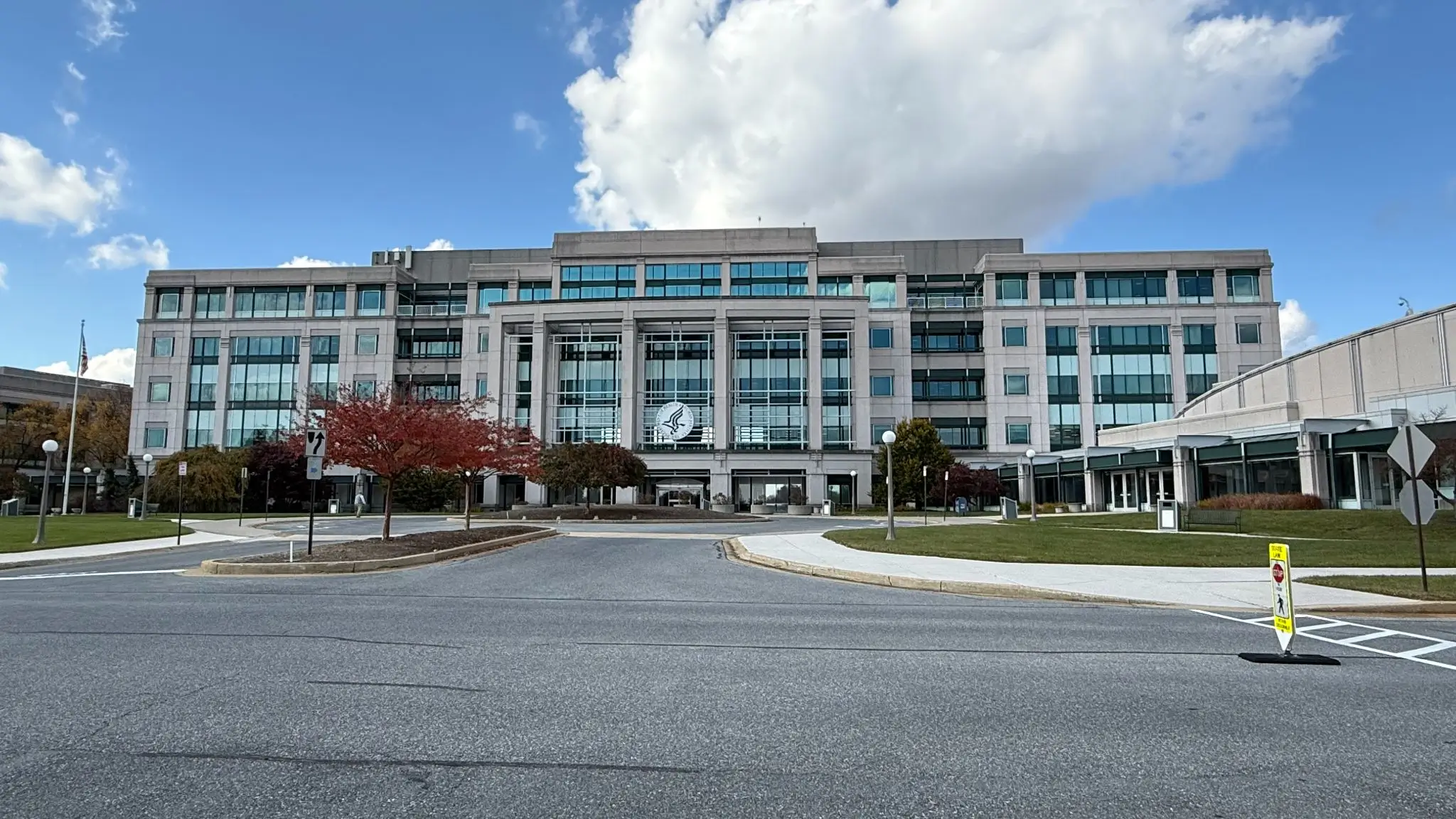 view of the headquarters building for the center for medicare and medicaid services in maryland with street in front and blue sky above